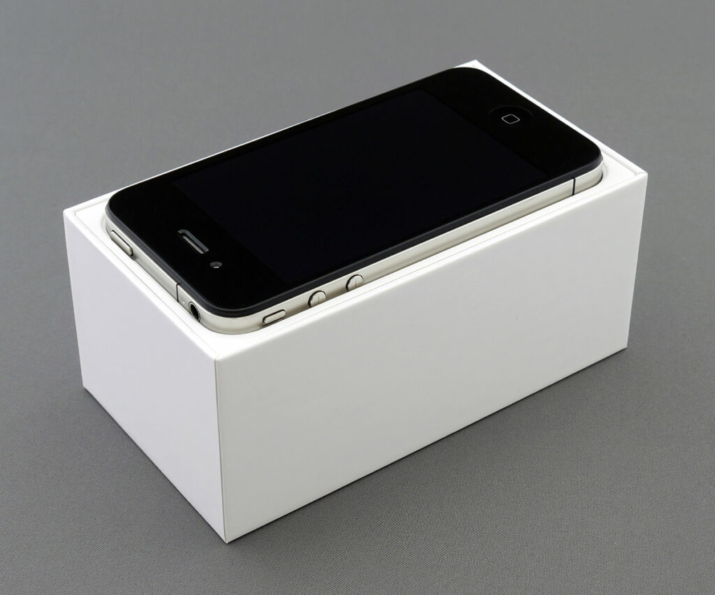 Smartphone packaged in a white box, showcasing a kitted product ready for shipment.