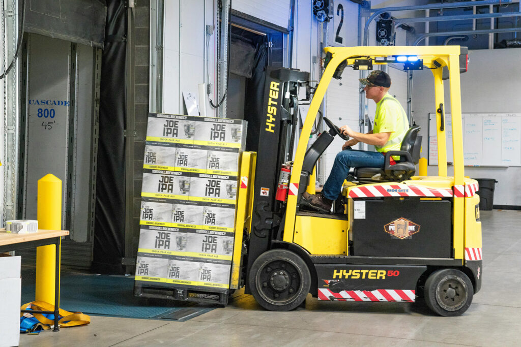 Forklift lifting pallet of beer