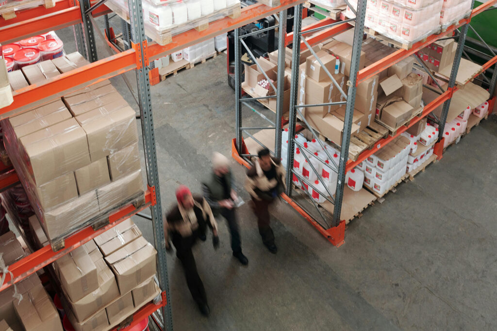 Top view of warehouse workers walking through Chicago public warehouse facility providing competitive logistics solutions for small businesses.