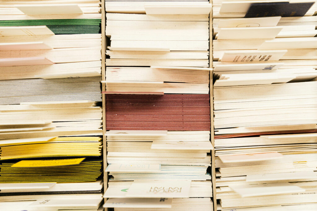 Close-up view of organized paper documents and files stored on industrial warehouse shelving system, demonstrating professional record archive storage and long-term document retention practices for Illinois businesses